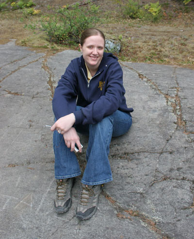 Gina sitting on rock polished by glacial ice.