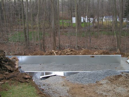 Outside walls of pool frame are strengthened by fill